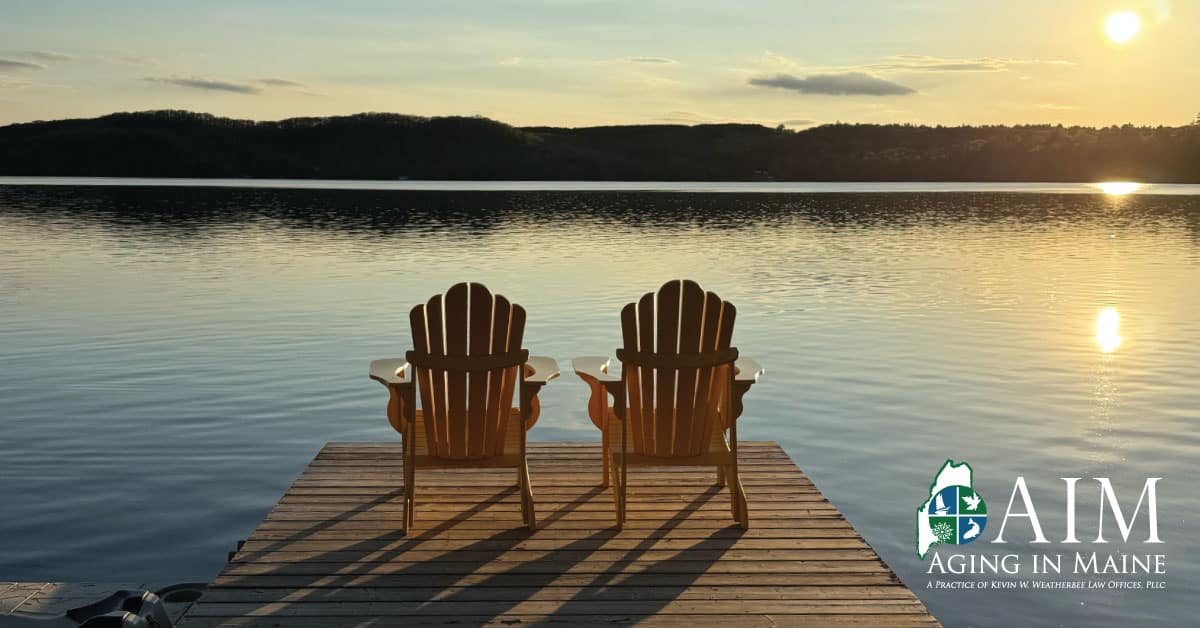 Two chairs on a dock overlooking a Maine lake at sunset, representing estate planning for a Maine family camp.