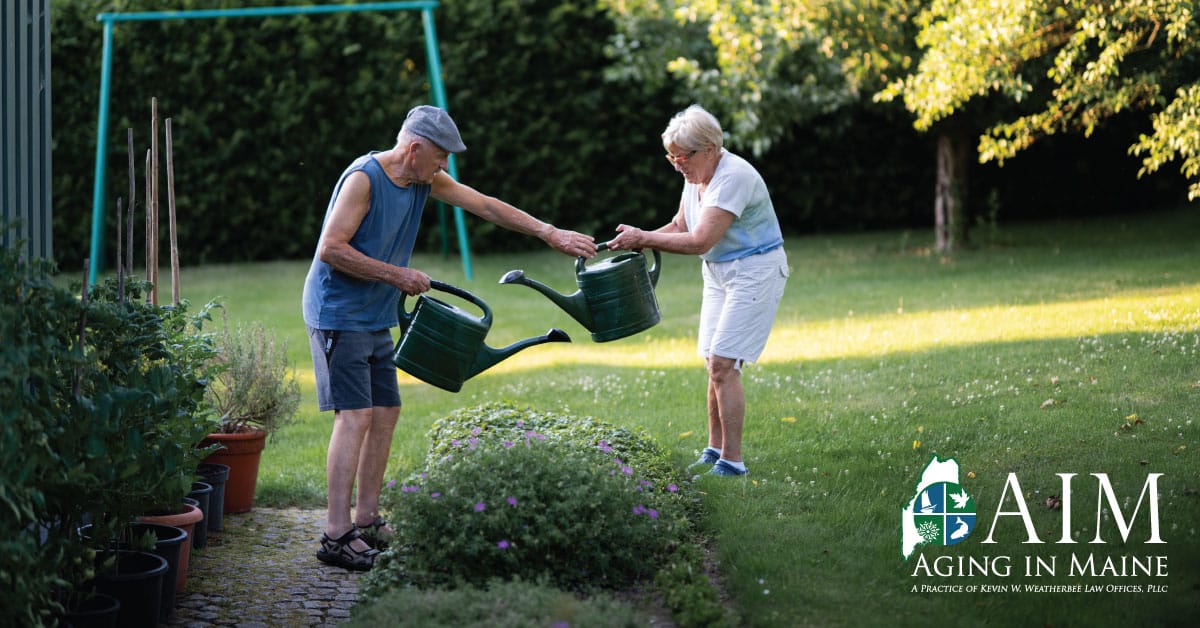 Older couple gardening together in their backyard during summer to support healthy aging in Maine.