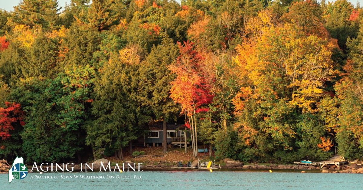 Maine family camp surrounded by colorful fall foliage, highlighting the importance of property ownership in estate planning.